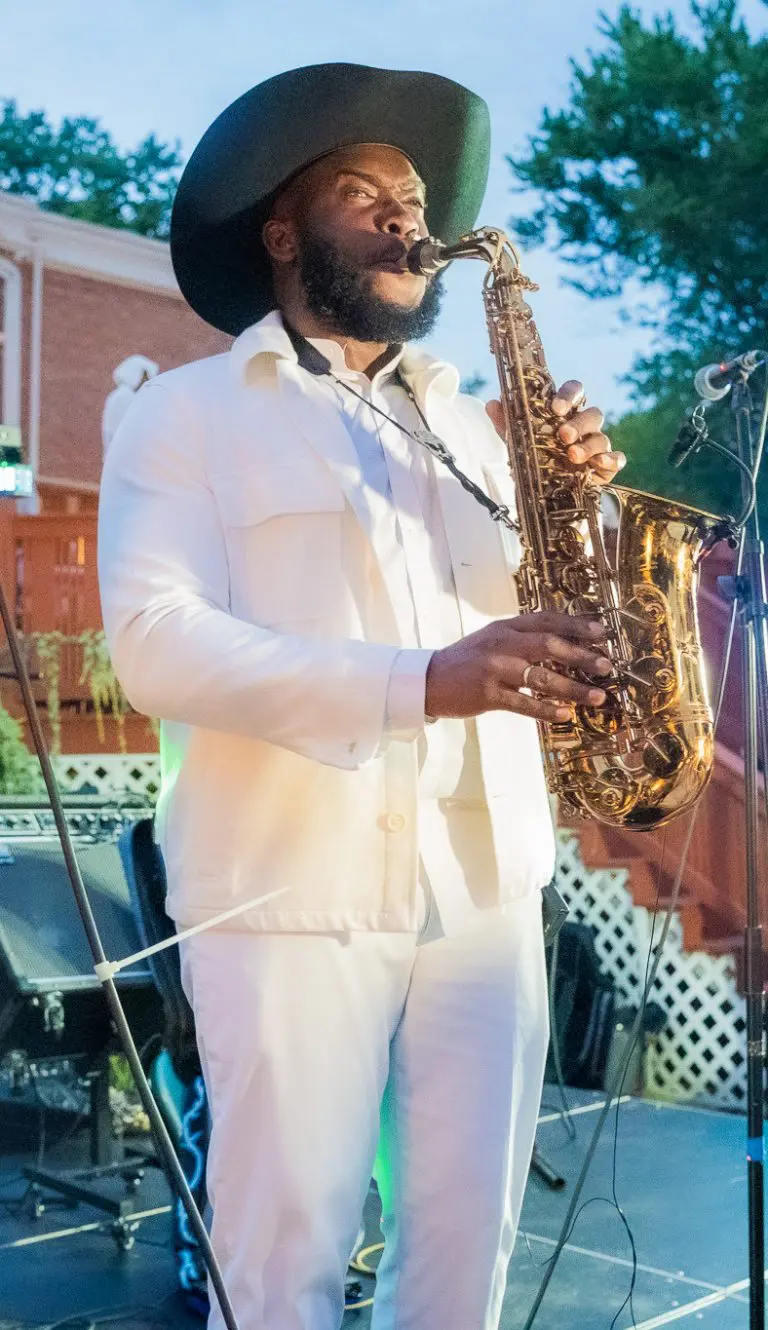 Saxophonist in white outfit performing
