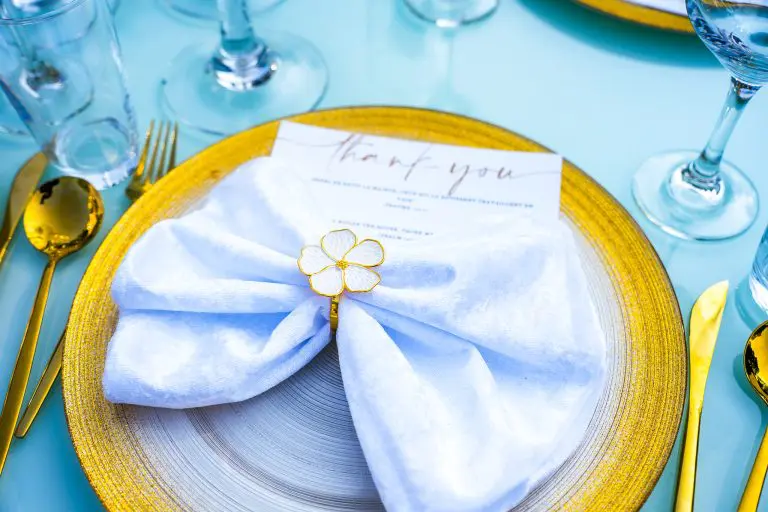 White napkin with gold flower accent